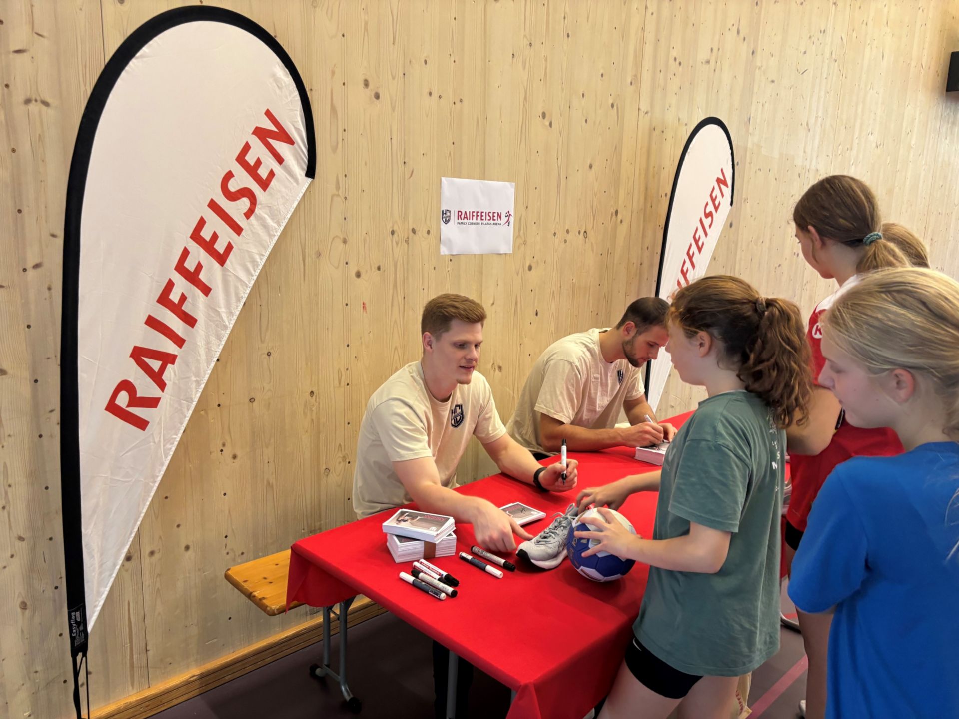 Autogrammtisch mit zwei Handballspielern