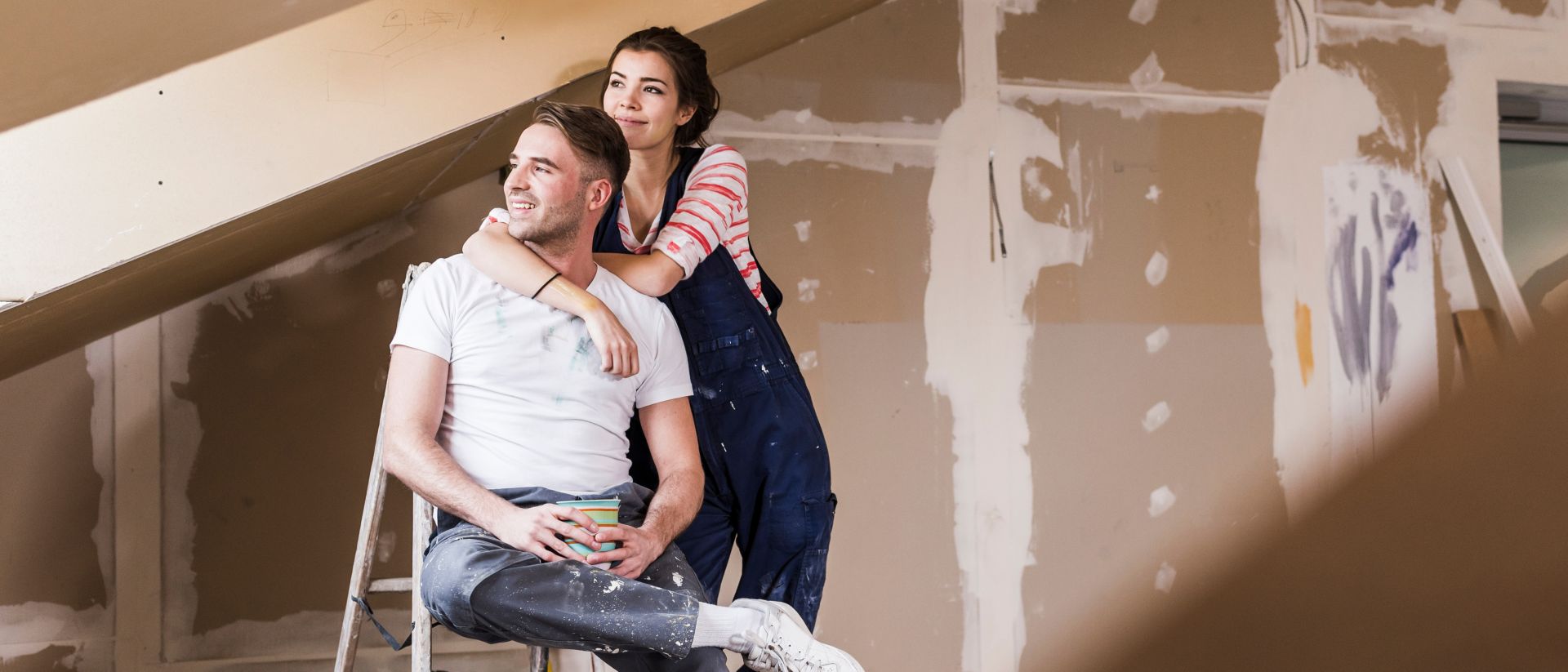 Young couple on construction site of their new home