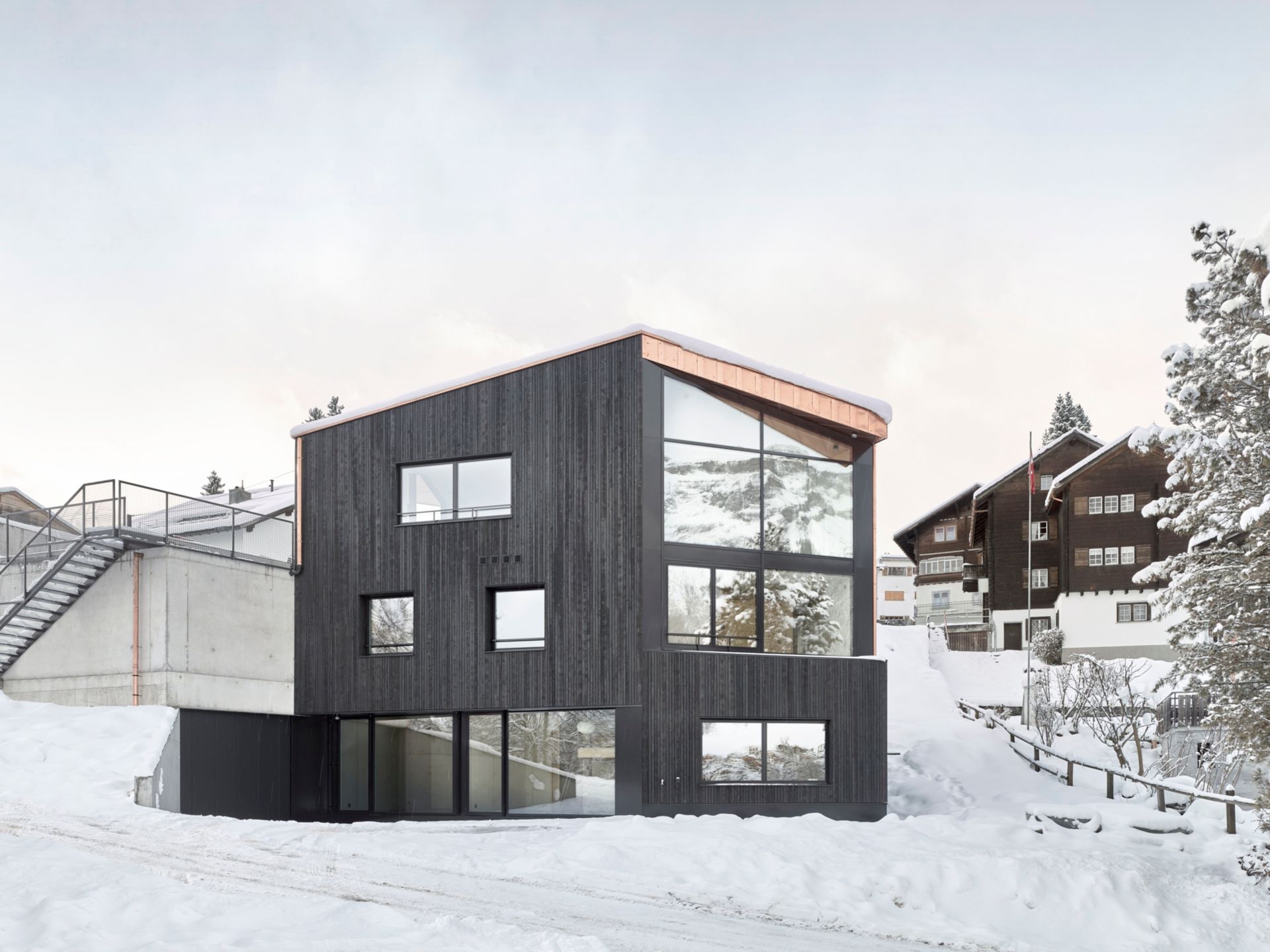 Le bois brut pré-carbonisé «shou sugi ban»  de la façade contraste fortement avec les ouvertures structurelles planes. Les décrochements de la façade sont placés avec précision et exécutés avec minutie.