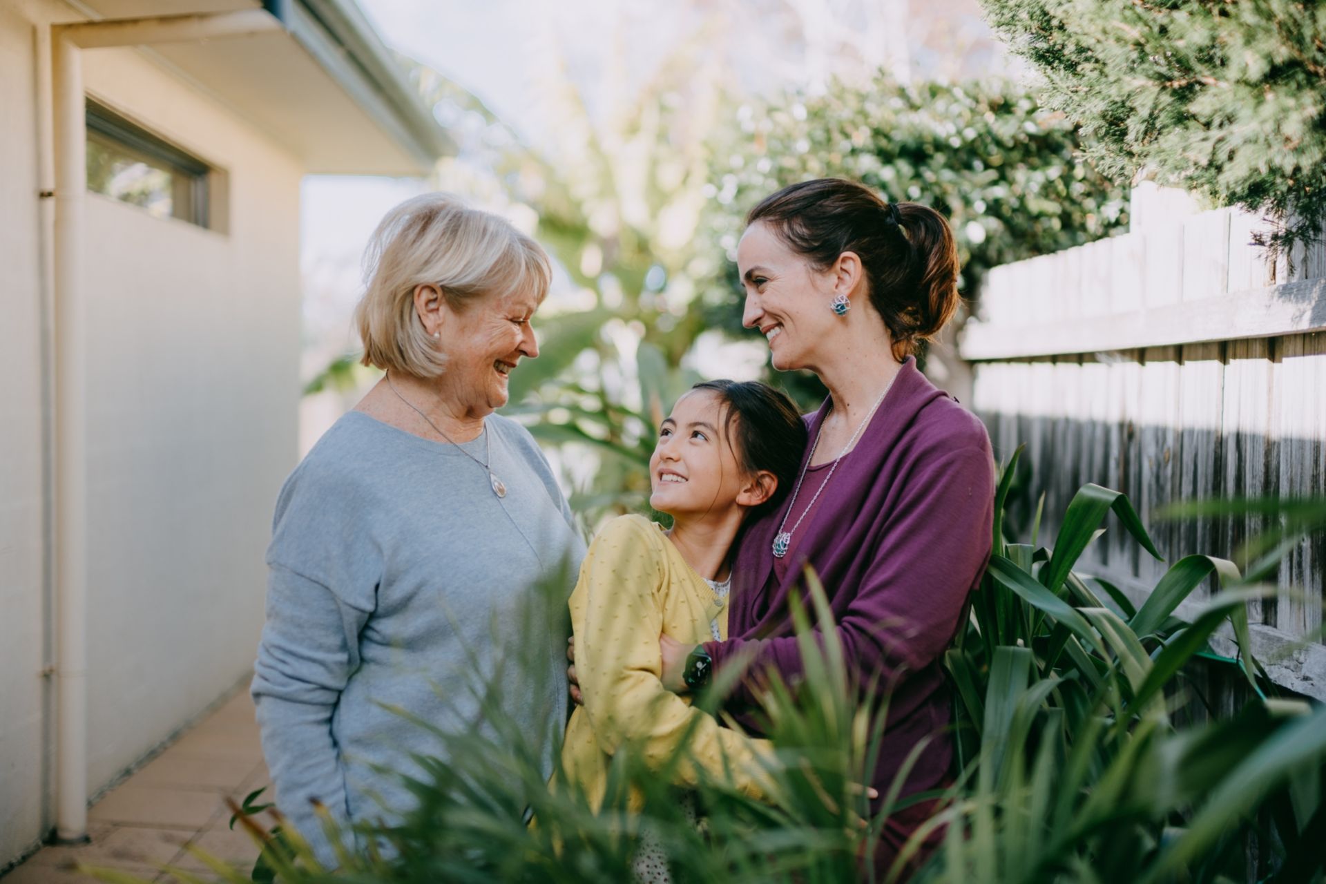 Grand-mère, mère et fille s'enlacent